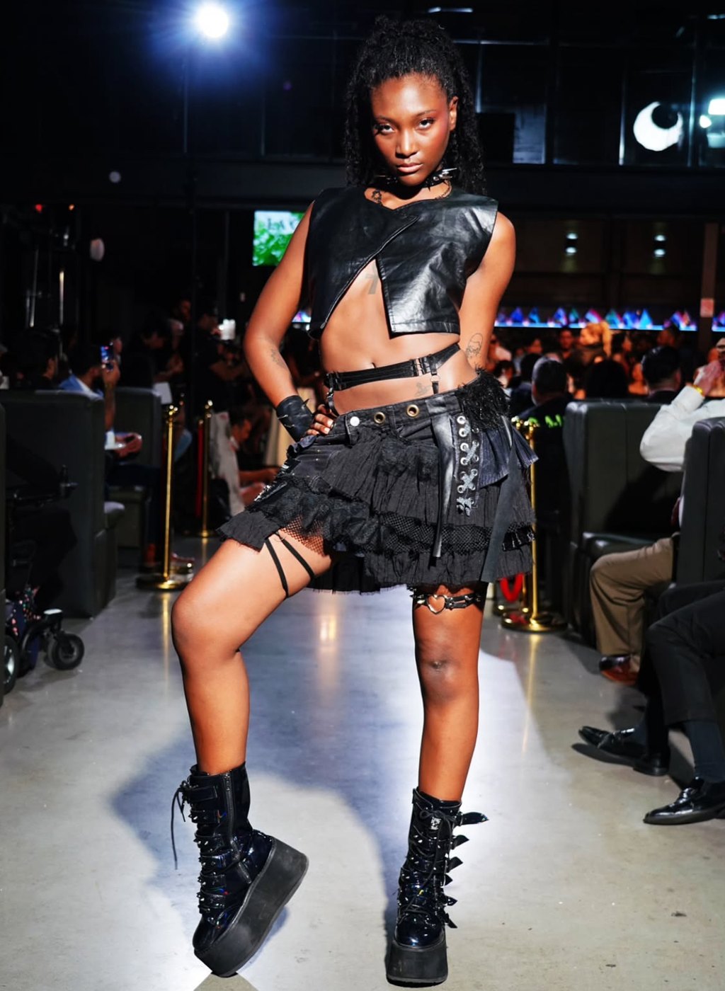 Leather crop vest, tiered black skirt and platform boots