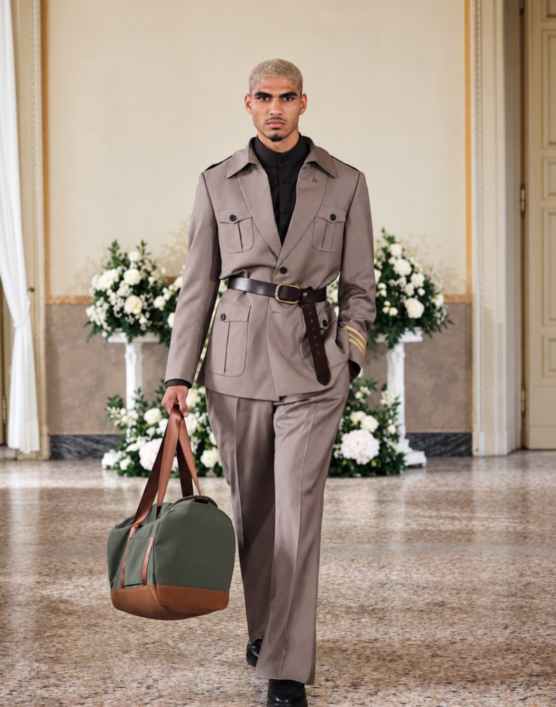 Taupe belted safari jacket and trousers with an olive and tan duffel