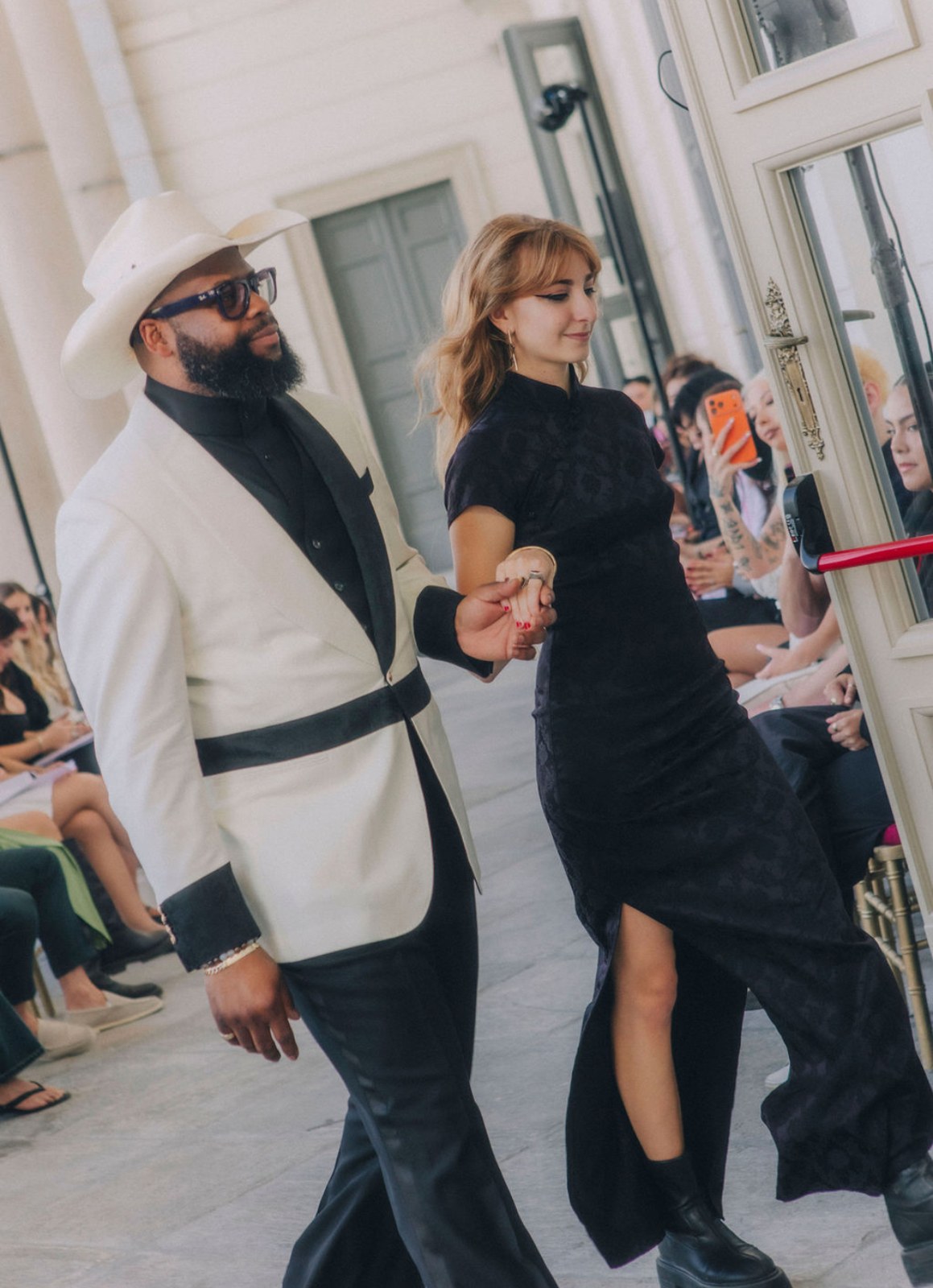 Isabella walking the finale hand in hand with the designer at Palazzo Clerici