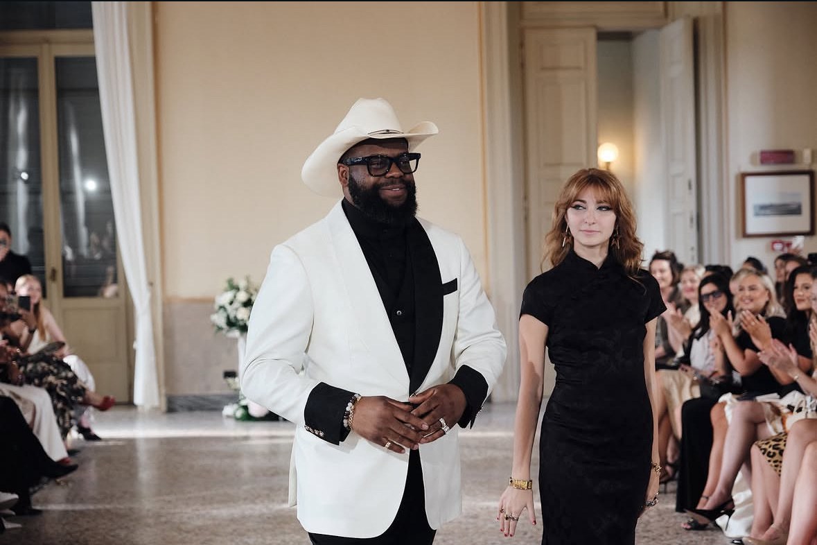 Isabella walking the DCASSO finale with the designer at Palazzo Clerici