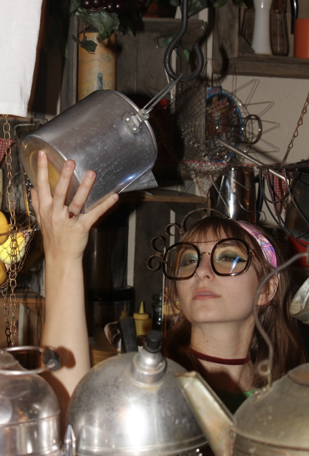 Isabella in oversized glasses holding a hanging pot